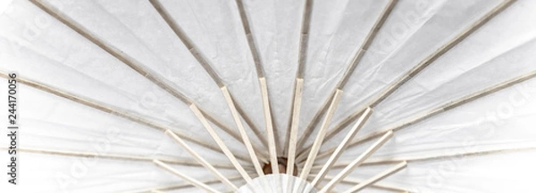 Fototapeta a fragment of umbrella construction made of wood and white paper