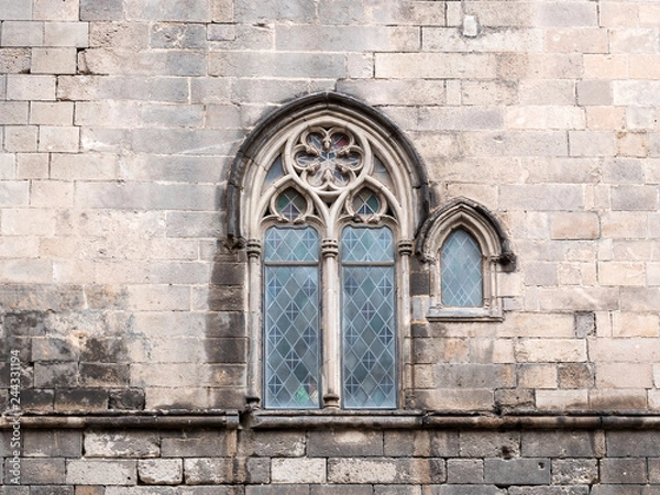 Fototapeta Traditional ancient gothic style window. Old vintage window on stone wall.