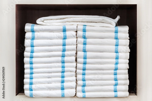 Fototapeta Stack of adult diapers on the shelf. Health care for elderly and bedridden people with urinary incontinence