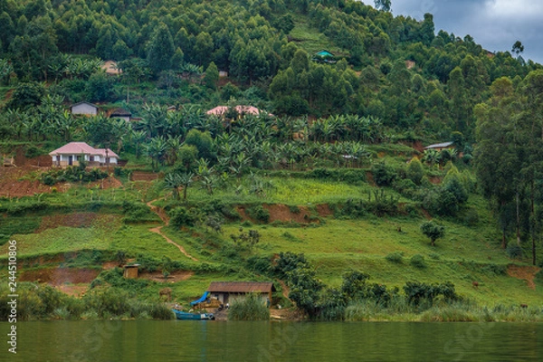 Obraz Local village in Bunyonyi lake with green hills. Uganda 