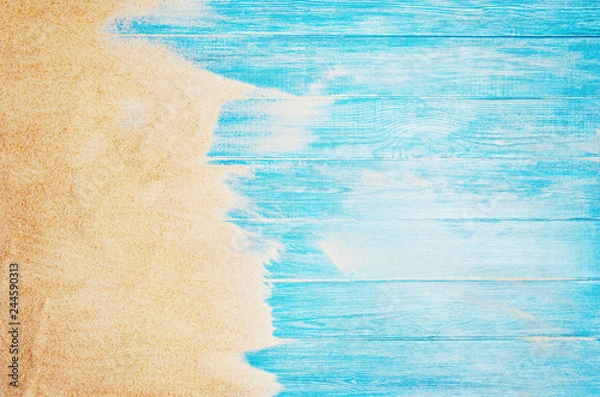 Obraz Top view of sandy beach and marine blue planks pier. Background with copy space and visible sand and wood texture.
