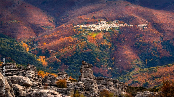 Obraz Majestic view of beautiful remote mountains in clouds and sunlight with town on hillside. Parauta in Malaga, Spain