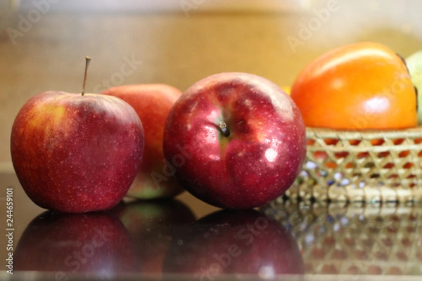 Fototapeta Two red ripe apples are on the table