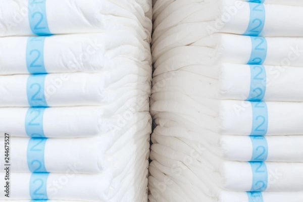 Fototapeta Stacks of adult diapers, closeup view. Health care for elderly and bedridden people with urinary incontinence