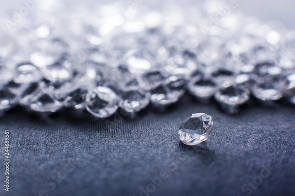 Fototapeta a scattering of artificial diamonds with bokeh on the background close-up