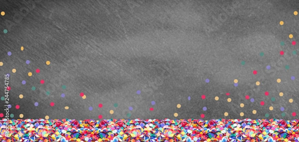 Fototapeta Colorful confetti in front of a slate board for carnival