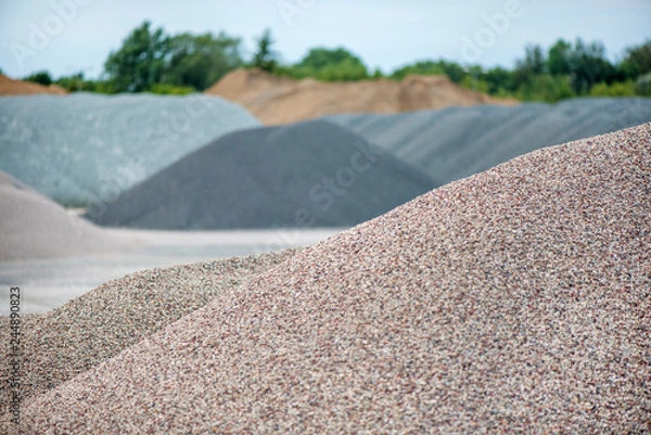 Obraz Large piles of construction sand and gravel used for asphalt production and building. Limestone quarry, mining rocks and stones 