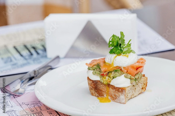 Obraz Toast with guacamole, salmon and poached egg.