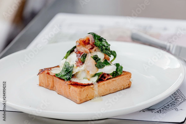 Obraz Eggs benedict with brioche, bacon and spinach.