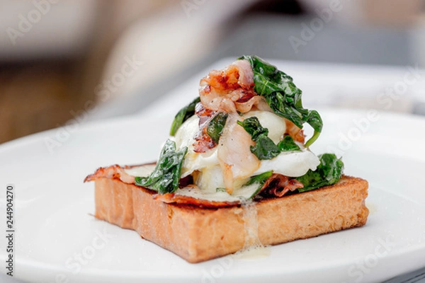 Obraz Eggs benedict with brioche, bacon and spinach.
