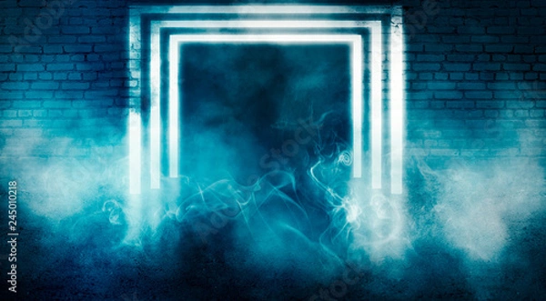 Fototapeta Background of empty dark room with brick walls, illuminated by neon blue lights with laser beams, smoke