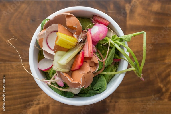 Fototapeta Compost Bowl Full of Organic Food Waste Such as Eggshells, Swiss Chard, Beet Tops and More