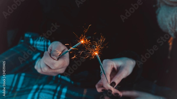 Obraz Bengal fire sticks, sparkling, burning, lovers hands fire