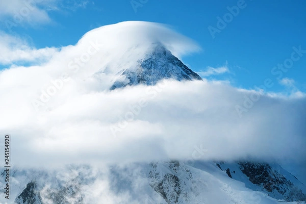 Obraz Snowy mountain peak inside clouds in Himalaya