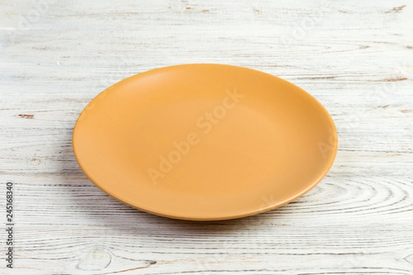 Obraz Perspective view. Empty yellow matte plate on white wooden background