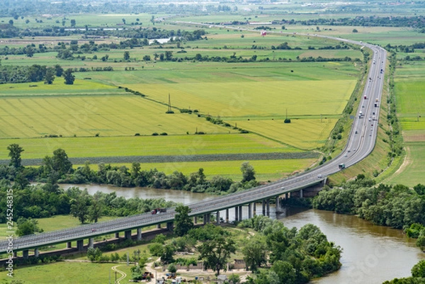 Fototapeta aerial view of highway in green fields
