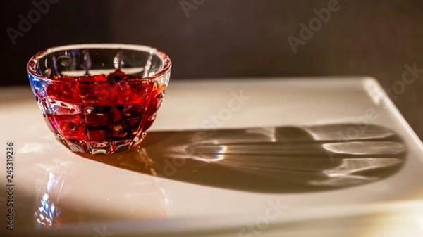 Obraz The saucer with raspberry jam with gray and brown background. This picture made by middle format camera.