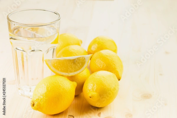 Obraz Glass of water with piece of lemon or fresh hand made lemonade