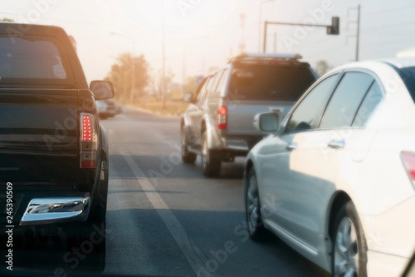 Fototapeta Cars on the road heading towards the goal of the trip.