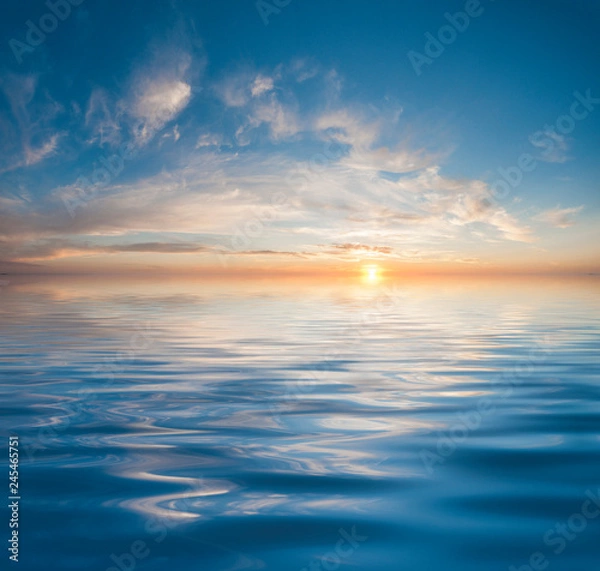 Fototapeta Sunset or sunrise over calm water
