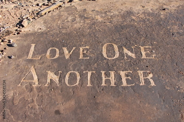 Obraz Love One Another carving in sandstone