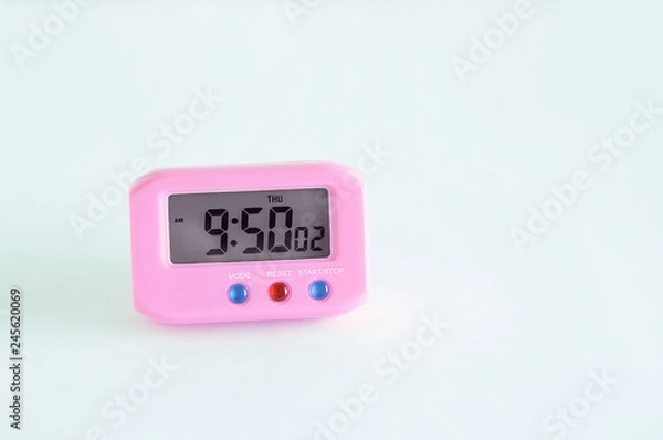 Obraz Pink electronic clock on a white background. Close-up.