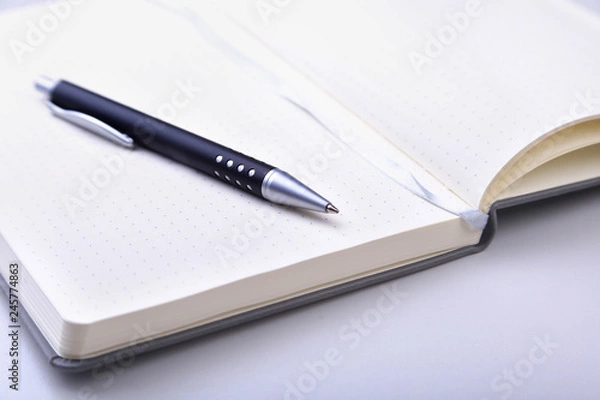 Fototapeta office table with notebook and pen. copy space.