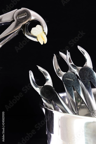 Fototapeta dental instruments. surgery. medical instruments with a torn tooth. installation (a tool with a torn tooth nourishes other tools) the day of the dentist. Day of the medical worker.