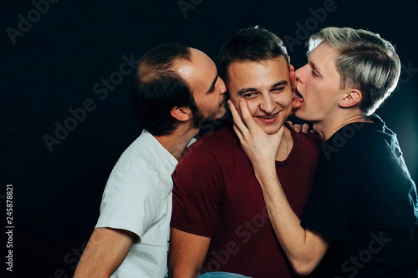 Fototapeta three guys are gay on dark background