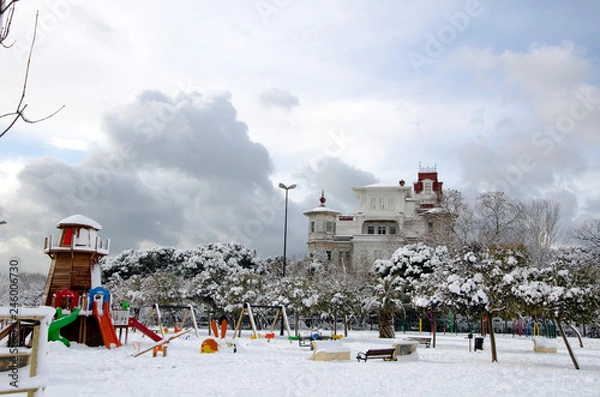 Fototapeta Mansion and playground under snow