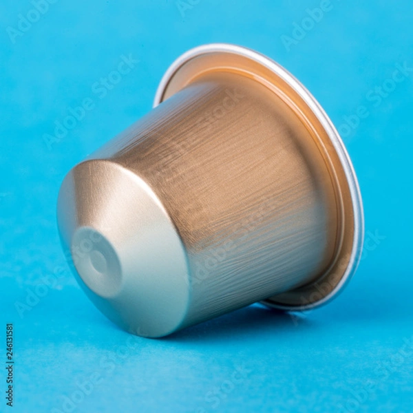 Obraz Golden coffee cup on a blue background. Modern conceptual art