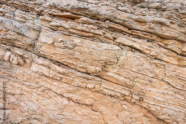 Fototapeta The close-up relief of the rocks texture with layers.
