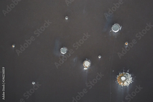 Fototapeta Armor shot through with bullets. Bullet holes
