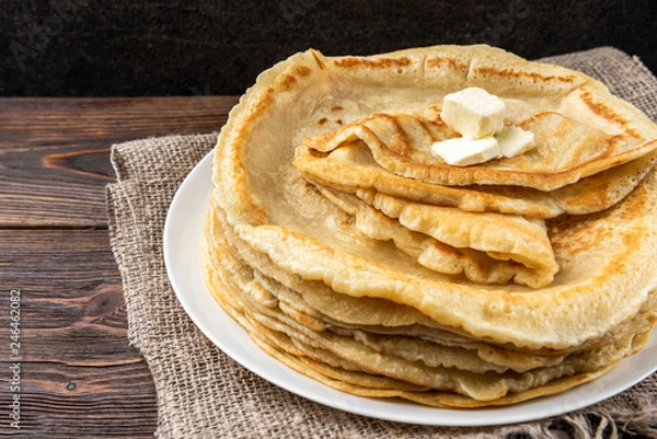 Fototapeta Stack of homemade pancakes blini on wooden background. Russian Maslenitsa, Shrove tide, pancake week, carnival, pancake day.