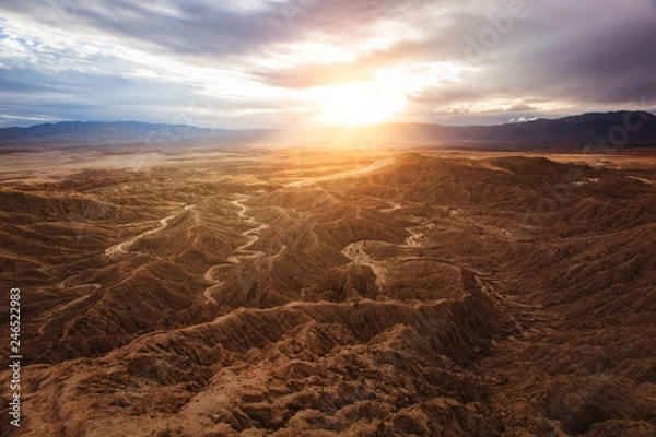 Fototapeta beautiful view of a desert landscape with a sunrise or sunset and blues skies with mountains 