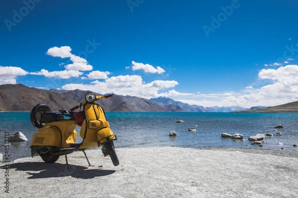 Obraz Yellow motocycle in front of clear natural water of lake Pangong in Ladakh, India