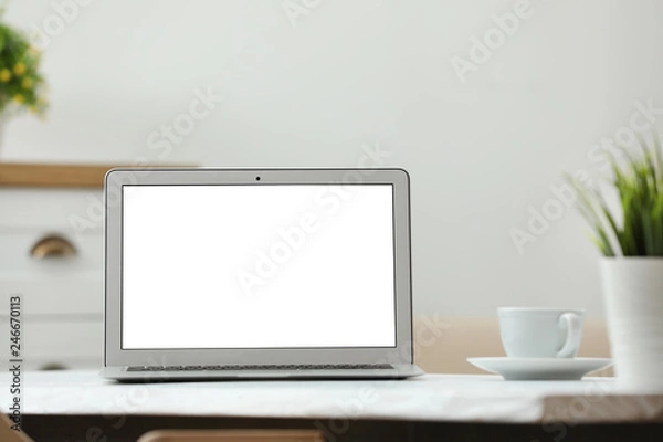 Fototapeta Laptop with blank screen on table indoors. Space for text