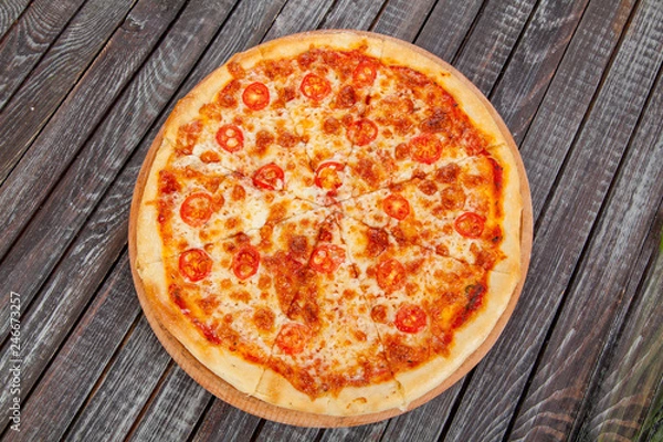 Fototapeta  appetizing, fresh pizza on the table, for a design decoration in cooking