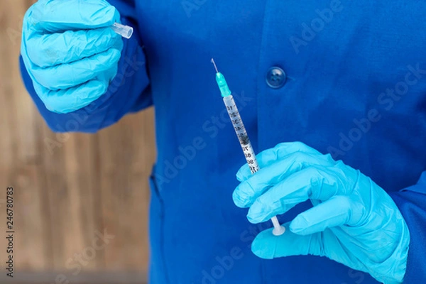 Obraz Ręka lekarza trzyma strzykawkę z lekiem. Choroby koncepcyjne, eutanazja, opieka medyczna, nauka, cukrzyca.