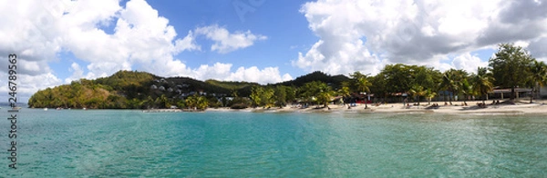 Obraz Superb panoramic view from the sea of the beautiful beach of Anse à l'Ane near the village of Trois-Ilets in Martinique facing the city of Fort-de-France