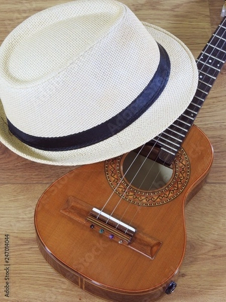 Obraz A samba player (sambista) hat and a cavaquinho, a small Brazilian string musical instrument. It is widely used to accompany samba and choro, two popular Brazilian rhythms.