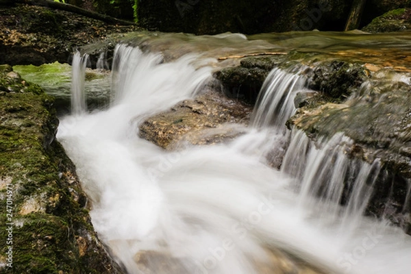 Fototapeta Water runs down a small stream, long exposure