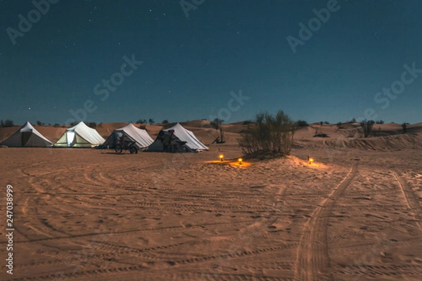 Obraz Amazing adventure trip in the Sahara desert, tent camp among the dunes under starry sky