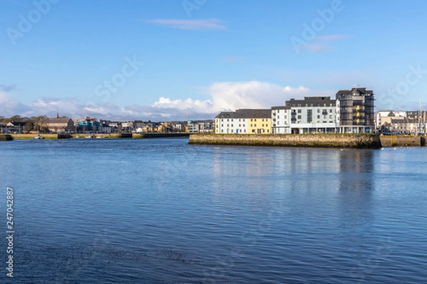 Fototapeta Corrib river and Galway buildings with reflection