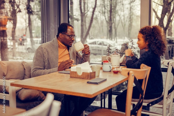 Obraz Father and daughter eating and drinking tea together after walking