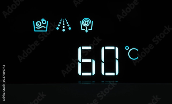 Fototapeta Washing machine panel display, setting 60 degrees temperature. Abstract hot water laundry programming backdrop, closeup.