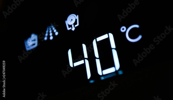 Fototapeta Washing machine panel display, setting 40 degrees temperature. Abstract laundry programming.