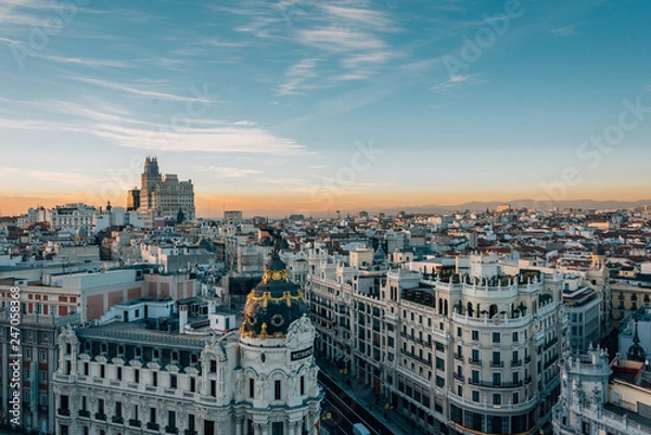 Fototapeta View of the Metropolis Building and Gran Via from the Circulo de Bellas Artes rooftop at sunset, in Madrid, Spain