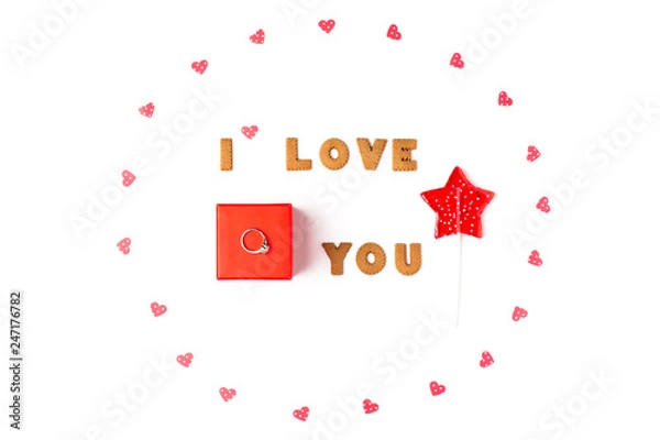 Obraz Valentine's day concept. Declaration of love, frame made of paper hearts, lollipop in form star. In the center red gift box with ring. Flat lay, top view, white background, isolated, copy space