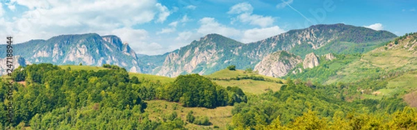 Fototapeta gorgeous panorama of countryside in springtime. beautiful landscape of romania. rural area on the near hills. distant ridge with rocks, cliffs and gorge. wonderful sunny forenoon